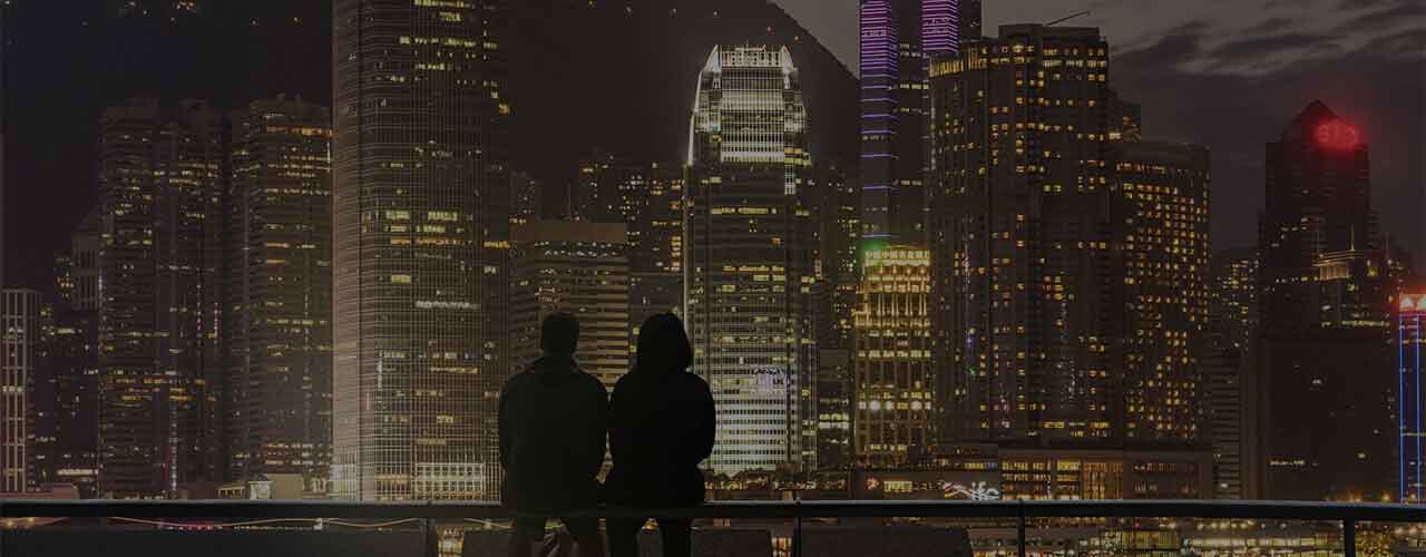 Beautiful night view of real estate buildings watching by two people together